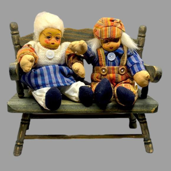 Grandma and grandpa sitting on a wooden bench - Picture 1 of 6